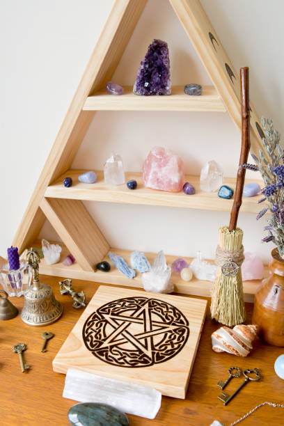 istock Pagan / Witch Altar with crystals, crystal stand, pentacle altar tile, besom, bell and herbs 1071555220
