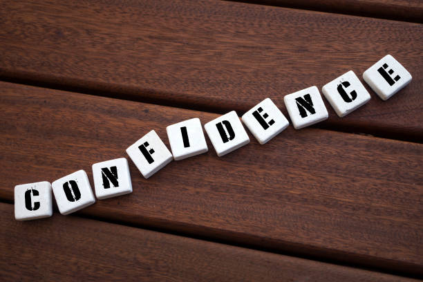 istock CONFIDENCE Concept with alphabet blocks on wooden table. 1071561978