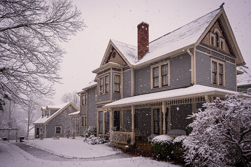 Victorian House During Snowstorm.