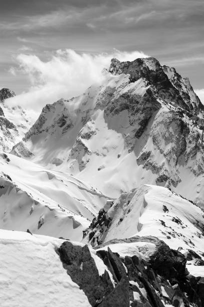 istock Black and white winter mountain with snow cornice 1071571594