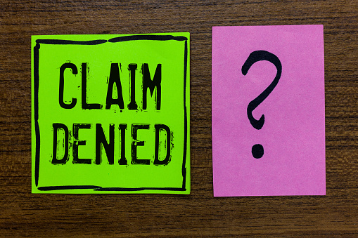 Handwriting text Claim Denied. Concept meaning Requested reimbursement payment for bill has been refused Green paper note Important reminder pink question mark wooden background