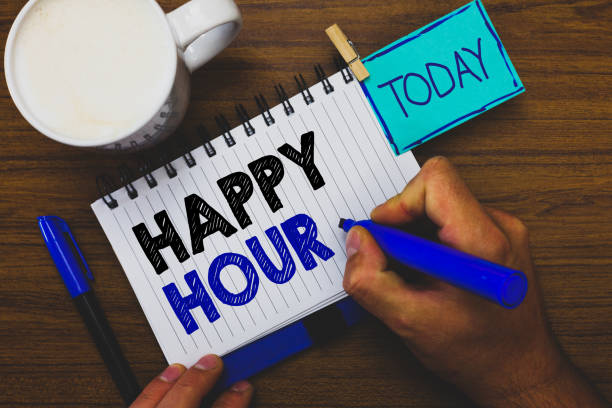istock Word writing text Happy Hour. Business concept for Spending time for activities that makes you relax for a while Man holding marker notebook clothespin reminder wooden table cup coffee. 1071571918