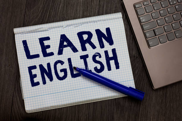 istock Conceptual hand writing showing Learn English. Business photo text Universal Language Easy Communication and Understand Open notebook squared page black marker computer wooden background. 1071572044