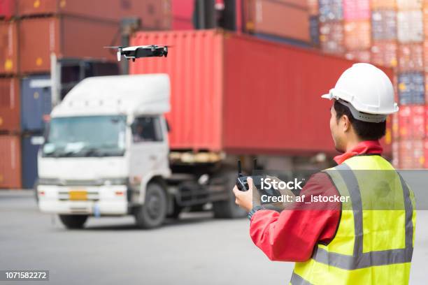 Foreman Control Drone To Fly To Survey The Area Worth In Container Yard Stock Photo - Download Image Now