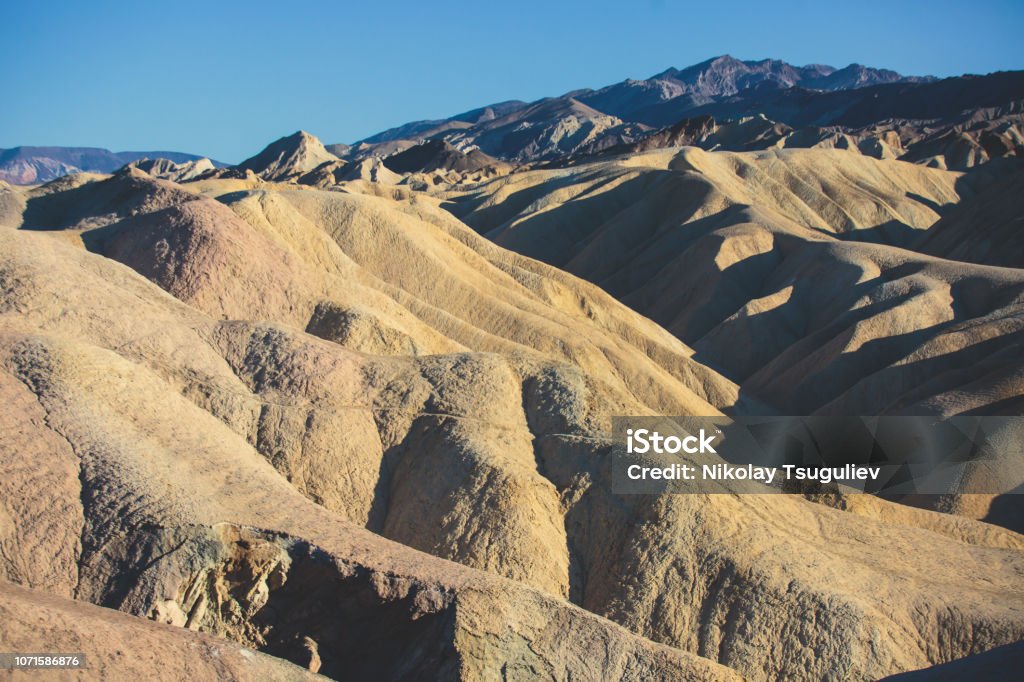 Vibrant panoramic summer view of Zabriskie point badlands in Death Valley National Park, Death Valley, Inyo County, California, USA Vibrant panoramic summer view of Zabriskie point badlands in Death Valley National Park, Death Valley, Inyo County, California, USA"n Arid Climate Stock Photo
