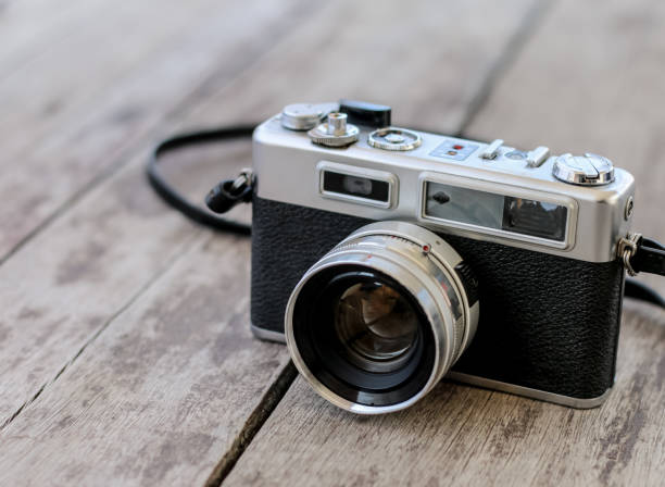 istock Old camera on old wooden background 1071593744