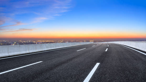 istock Asphalt road and modern city skyline at night 1071596630