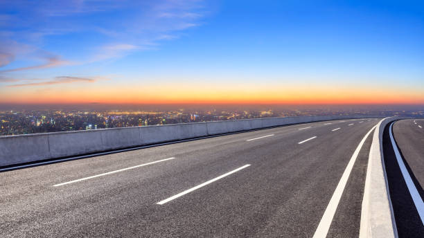 istock Asphalt road and modern city skyline at night 1071596632