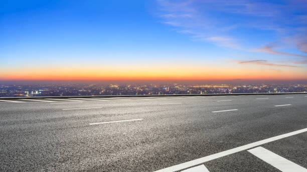 istock Asphalt road and modern city skyline at night 1071597022
