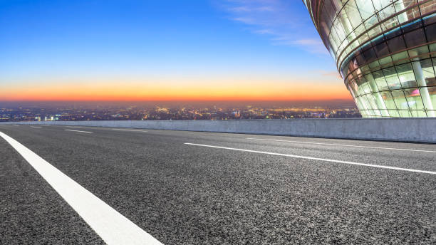 istock Modern city skyline and buildings with empty road at night 1071597032