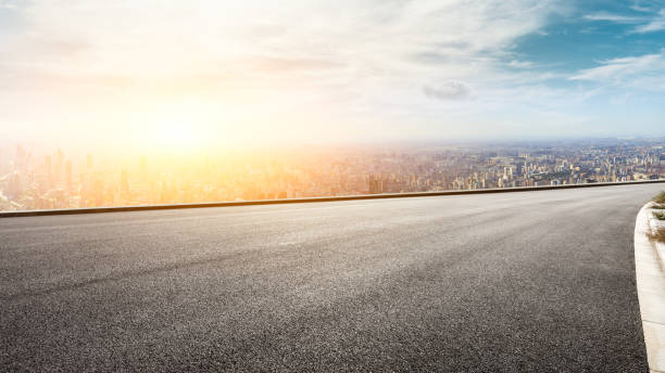 istock Panoramic city skyline and buildings with empty road at sunset 1071598628