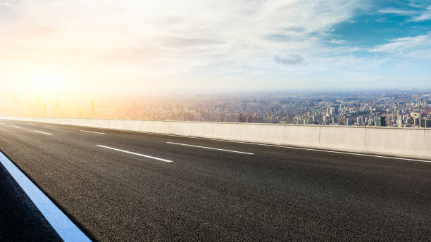 istock Panoramic city skyline and buildings with empty road at sunset 1071598892