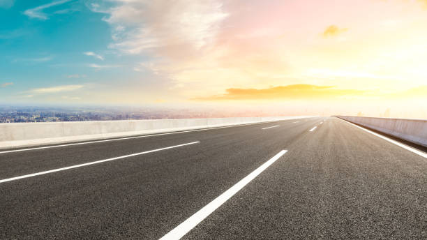 istock Panoramic city skyline and buildings with empty road at sunset 1071601618