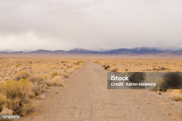 Lonely And Empty Abandoned Desert Road With A Storm Coming Stock Photo - Download Image Now