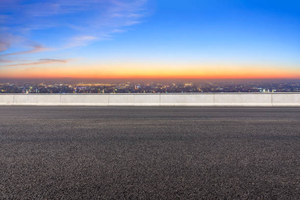 istock Asphalt road and modern city skyline at night 1071602914