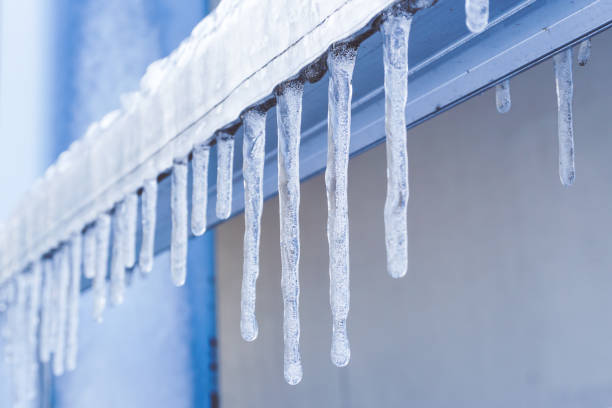 istock Icicle is hanging from a roof 1071603668