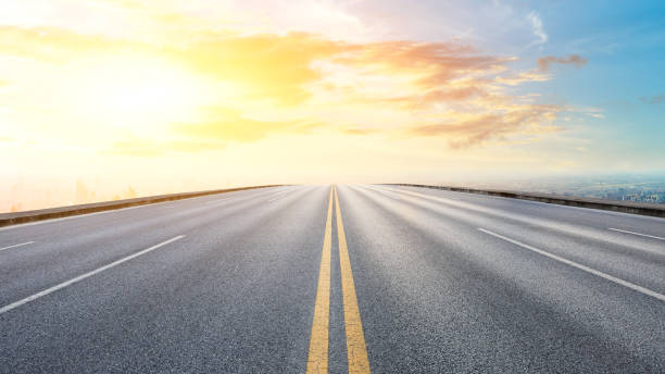 istock Panoramic city skyline and buildings with empty road at sunset 1071603710
