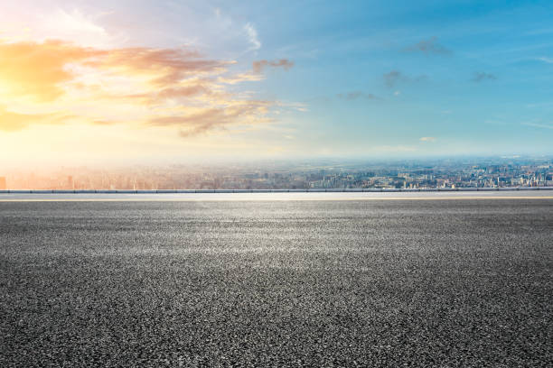 istock Panoramic city skyline and buildings with empty road at sunset 1071603734