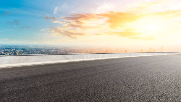 istock Panoramic city skyline and buildings with empty road at sunset 1071608026