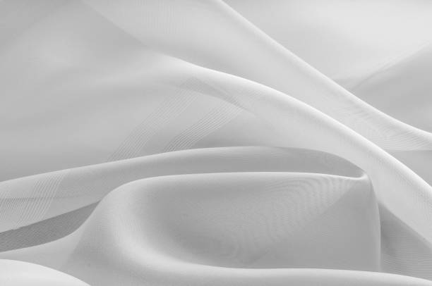 istock Texture, background, pattern. Silk fabric is transparent, white in color. Abstract soft chiffon texture background. Soft white chiffon with curve and wave 1071611160