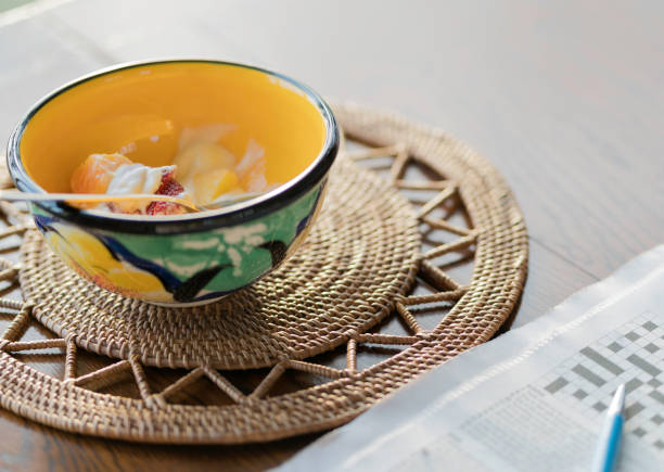 istock Breakfast bowl and newspaper with cryptic crossword puzzle 1071612660