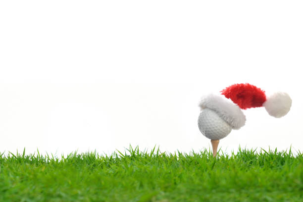 istock Festive-looking golf ball on tee with Santa Claus' hat on top 1071614734