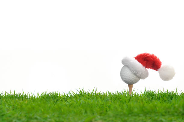 istock Festive-looking golf ball on tee with Santa Claus' hat on top 1071614746