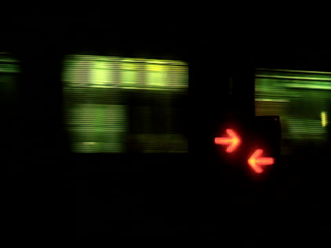 Trains pass railroad crossing night time