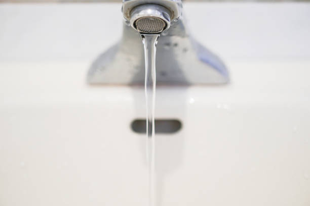 istock Faucet with water.Drop of water. 1071621430