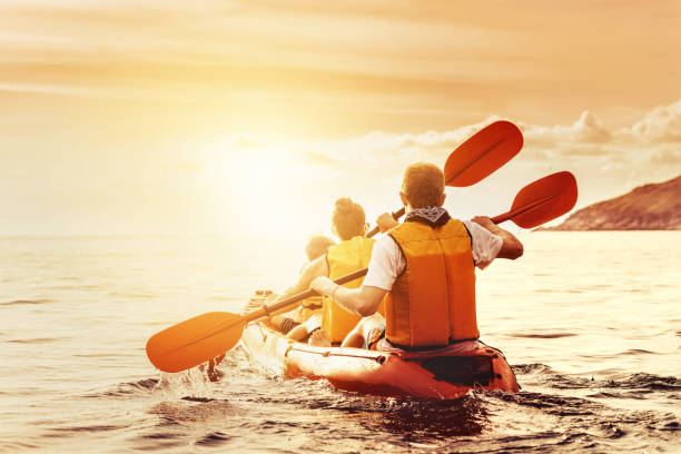 Family with son walking kayak kayaking sunset