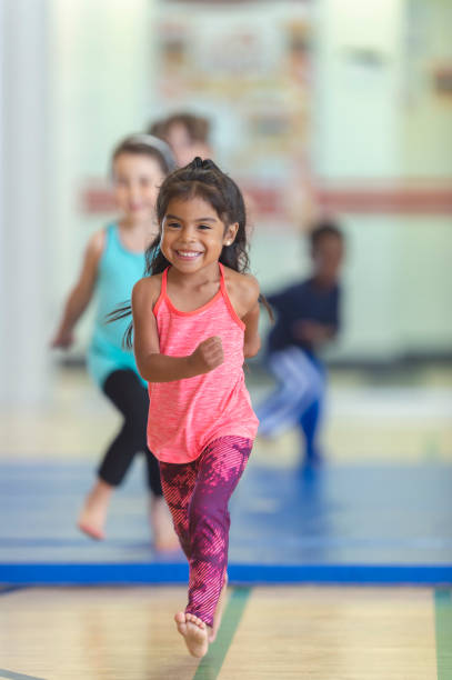 istock Young girl running in gym class 1071633348