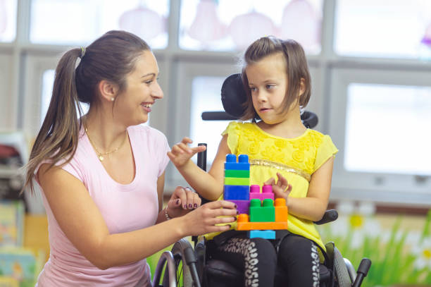 istock Girl using a wheelchair at daycare 1071633428