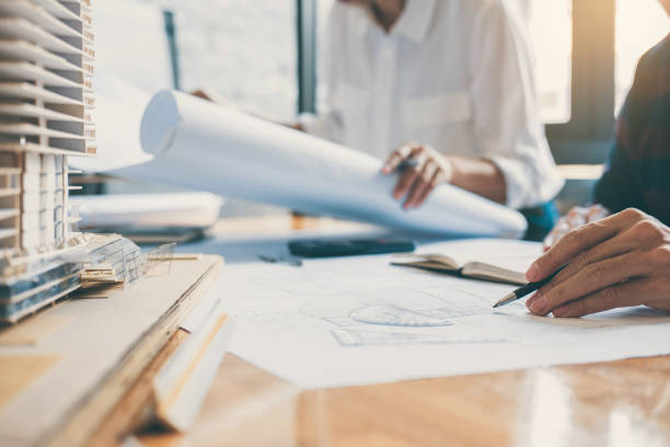 istock Image of engineer or architect partner meeting for working with architectural project, drawing and sketching for inspection architectural project on blueprint at workspace 1071652492