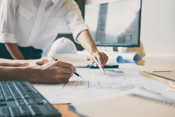 istock Team of Construction engineering or architect hands working on blueprint inspection in workplace, drawing and sketching meeting for architectural project working with partner 1071652494