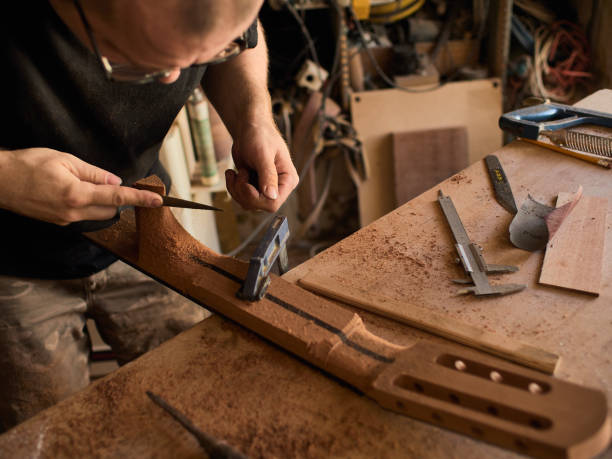 istock The guitar master makes a guitar neck. 1071654056