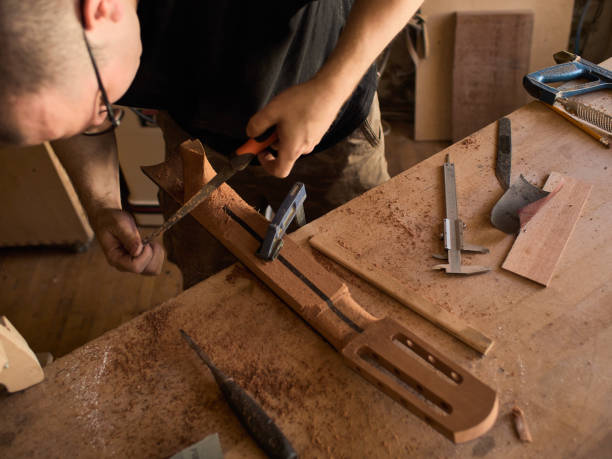 istock The guitar master makes a guitar neck. 1071654060