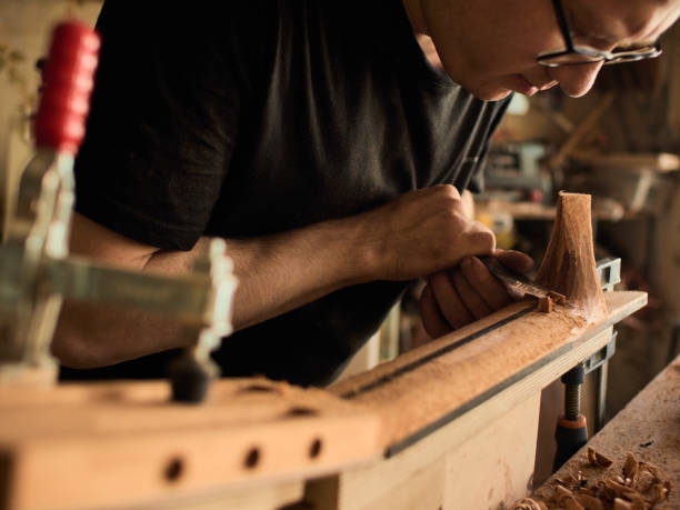 istock The guitar master makes a guitar neck. 1071654080