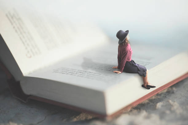 surreal moment of a woman relaxes sitting on a giant book surreal moment of a woman relaxes sitting on a giant book poetry literature stock pictures, royalty-free photos & images