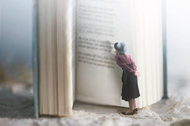 Curious woman reads a giant book stock photo