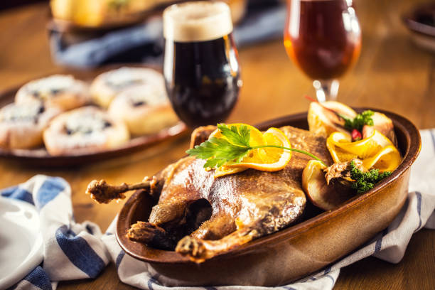Roasted christmas duck leg red cabbage dumplings liver draft beer and baked buns.