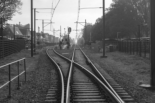 Scenic view of a junction of railroad tracks. Black and White photograph.