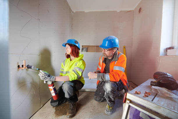 female plumbing trainee with supervisor