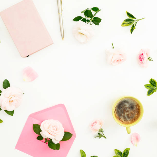 istock Valentines day composition with roses, paper envelope, notebook and mug of cappuccino white background. Flat lay, top view. Frame with copy space 1071690004