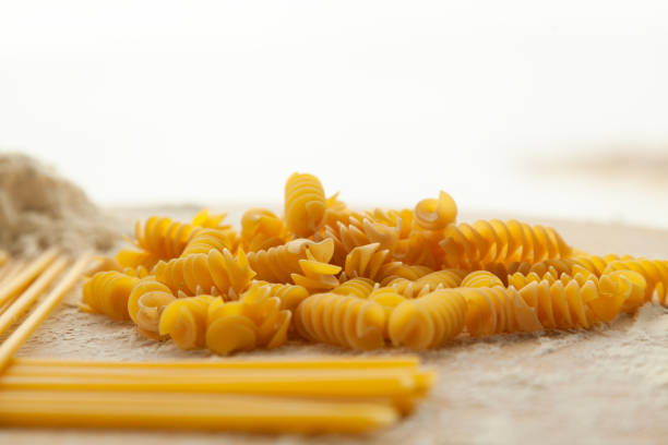Top view on raw homemade pasta with flour stock photo