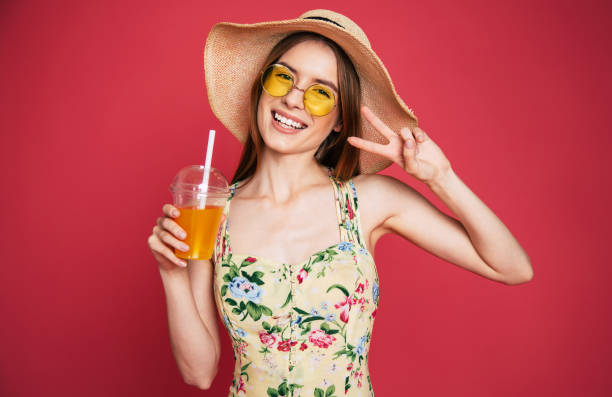 istock Happy woman with juice in summer hat 1071692150