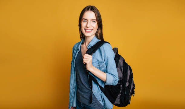 Portrait of young student girl portrait in glasses with backpack stock photo