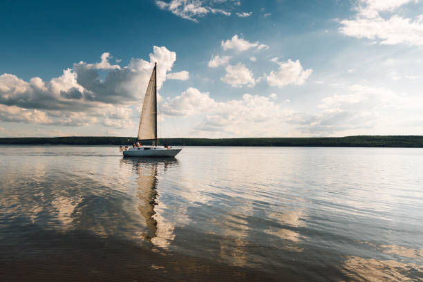istock landscape. boat with a sail on the lake at sunset 1071693668