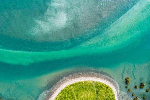 istock Looking down at texture of sand and water on beach. 1071698690