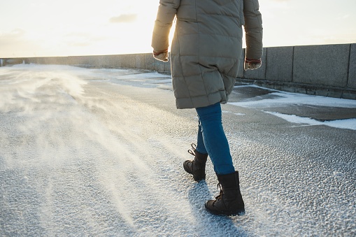 Woman walking in snowy winter landscape