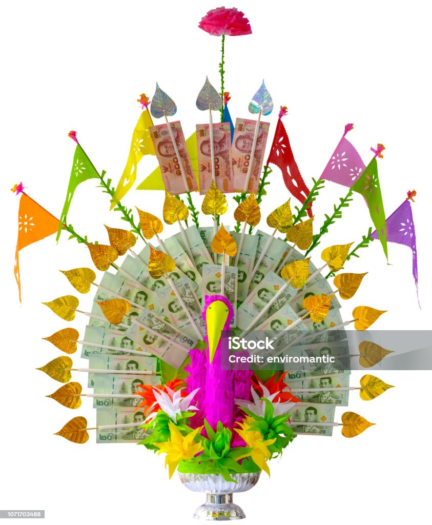 Colorful craft made elaborate Thai traditional Krathin Buddhist ceremony money tree offering, complete with Thai bank notes, in the shape of a peacock, isolated on white, clipping path included. Colorful craft made elaborate Thai traditional Krathin Buddhist ceremony money tree offering, complete with Thai bank notes, in the shape of a peacock, isolated on white, clipping path included. This offering is given to Thai Buddhist monks a the Thai Krathin Buddhist ceremony, which is held in November each year. The ceremony is held at Buddhist Temples all across Thailand and is celebrated as paying homage to the Thai Buddhist Monks by offering money trees and gifts of useful needed daily household items. Abstract Stock Photo